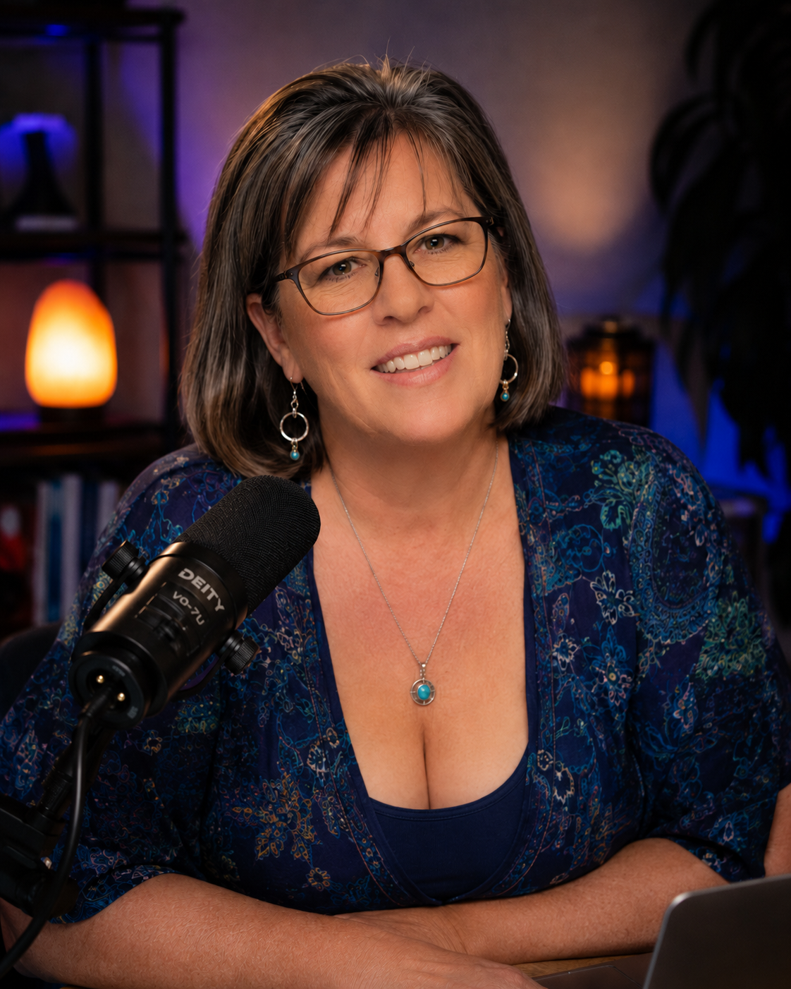 Jenn Burleton speaking into a microphone in a studio.