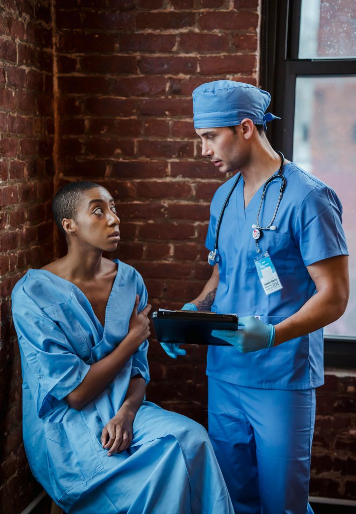 A healthcare professional consults with a patient in a calm clinic setting.